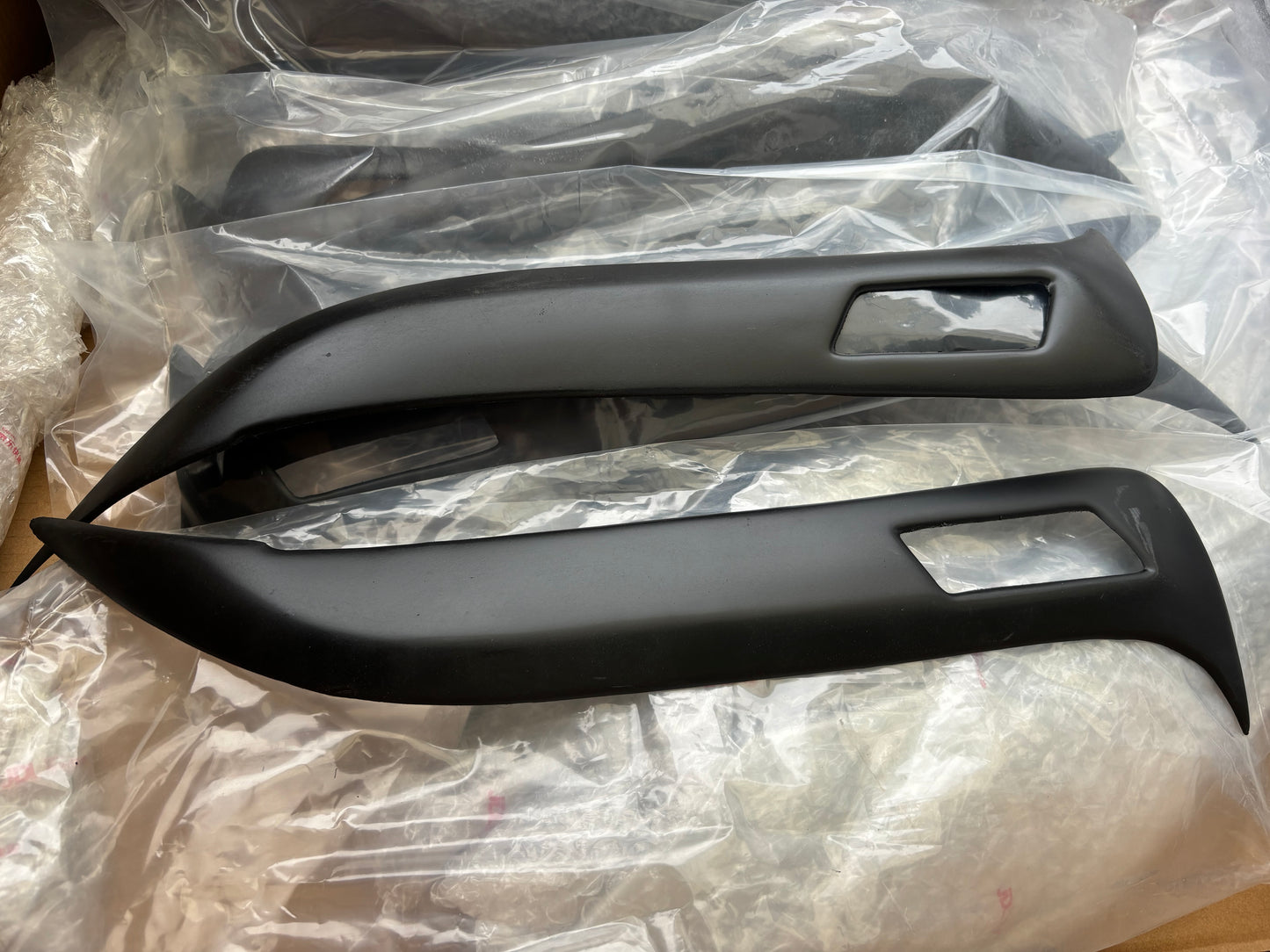 Two car door handles on a transparent plastic sheet